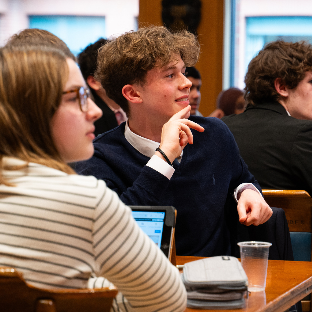 Students engaged in business simulation discussion