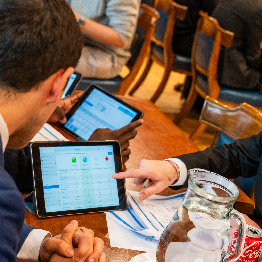 Students using tablets during business simulation